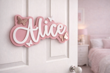 Pink decorative sign with 'Alice' on a white door in a bedroom setting