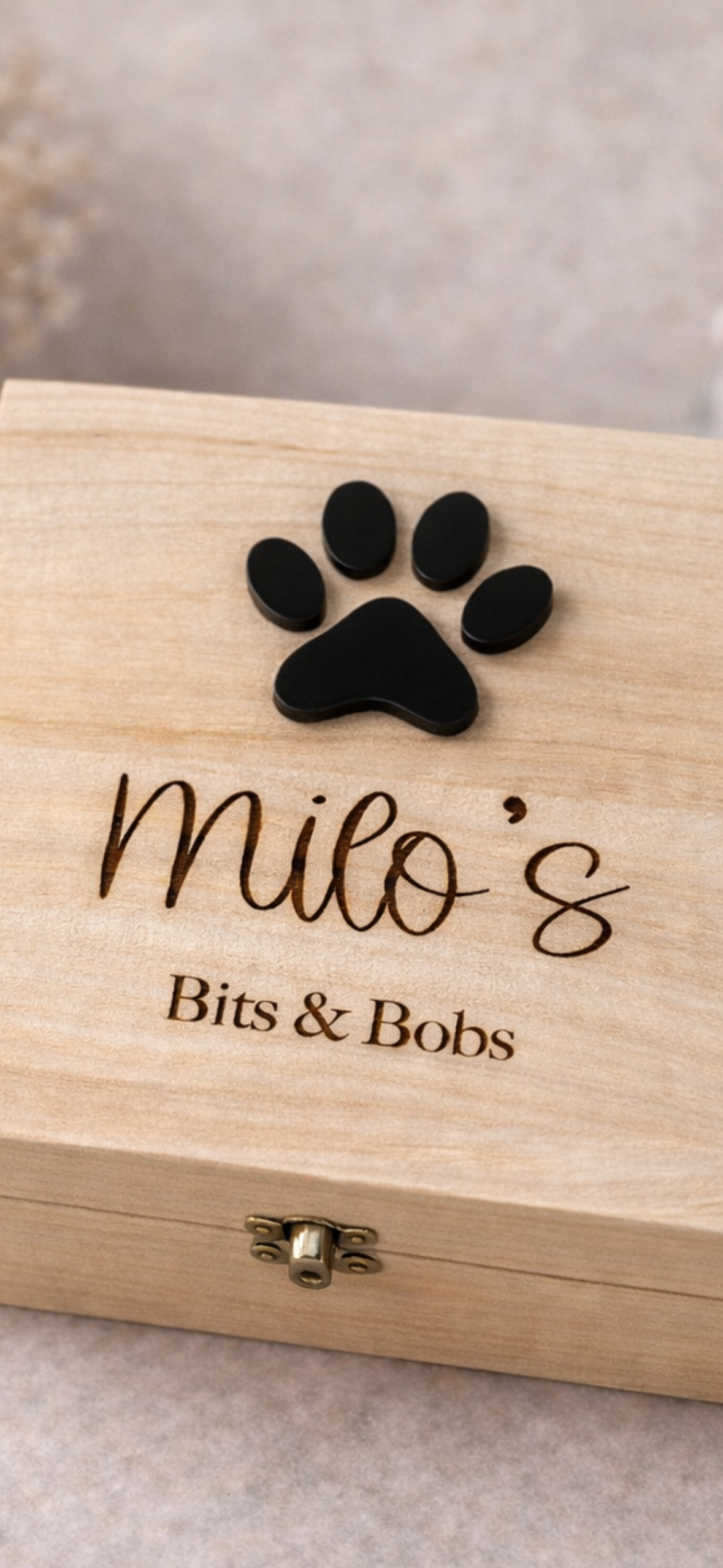 close up of engraved personalised dog keepsake box with paw details and custom name 