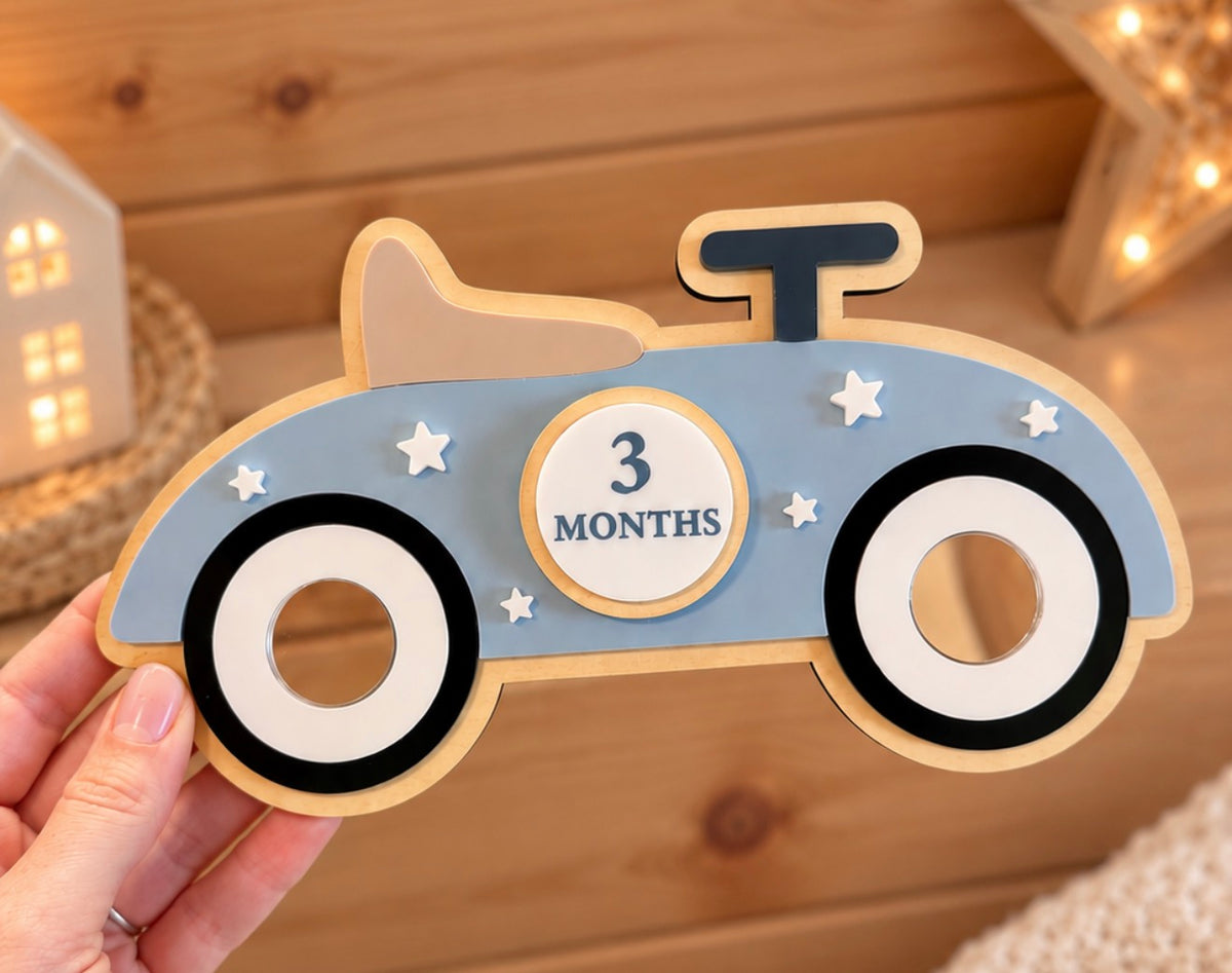 3 month baby milestone disc displayed in vintage car photo prop